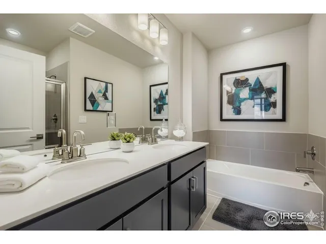 a bathroom with a tub a sink and mirror