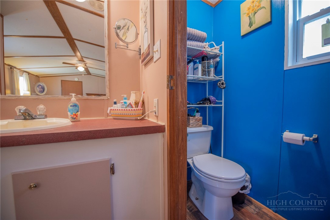 1848 West Mill Creek Road Warrensville, NC 28693 - Photo 33 of 50 a bathroom with a toilet a sink and mirror