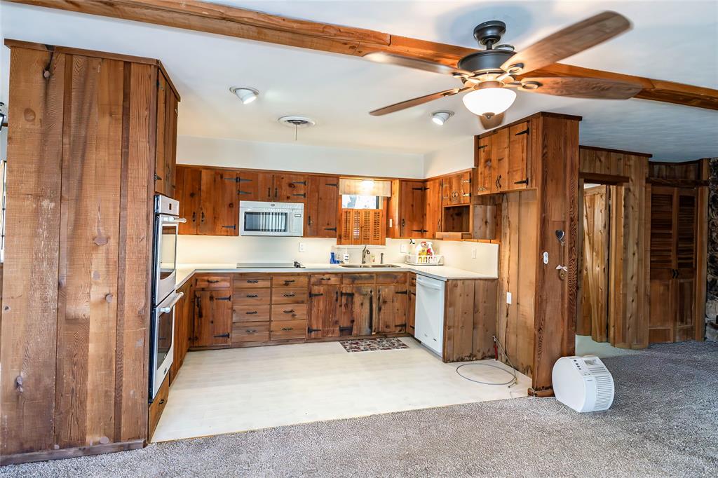 722 Storey Road Nocona, TX 76255 - Photo 24 of 40 a large kitchen with a large island a sink stainless steel appliances and cabinets