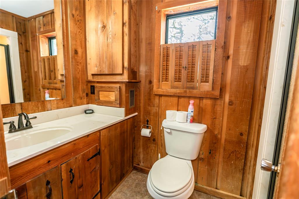 722 Storey Road Nocona, TX 76255 - Photo 25 of 40 a bathroom with a sink a toilet and shower