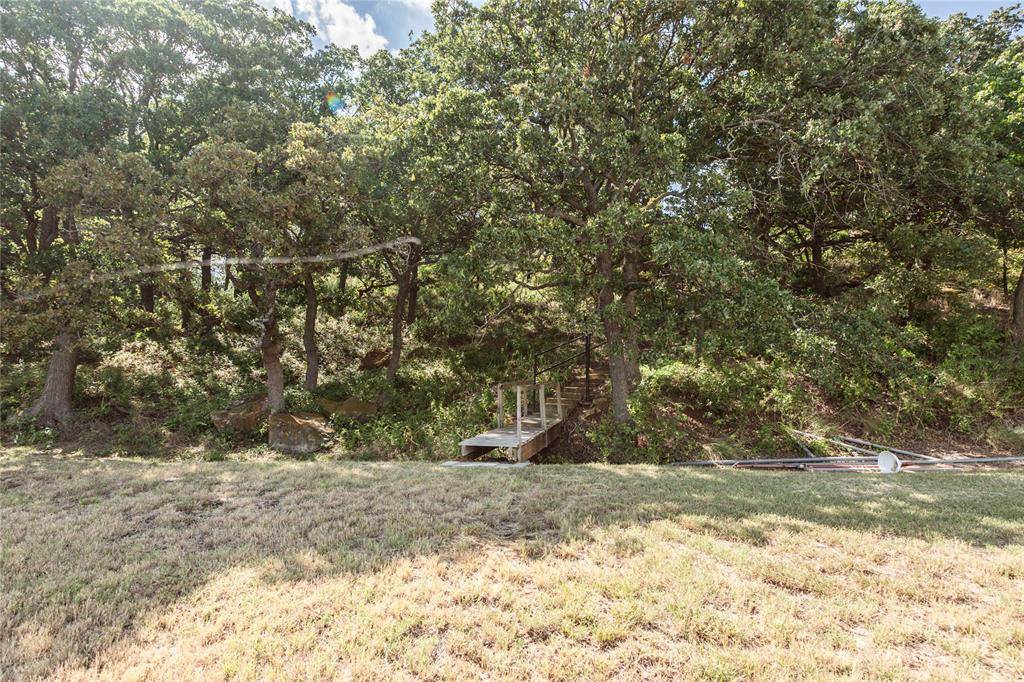 722 Storey Road Nocona, TX 76255 - Photo 28 of 40 a view of a yard with a tree