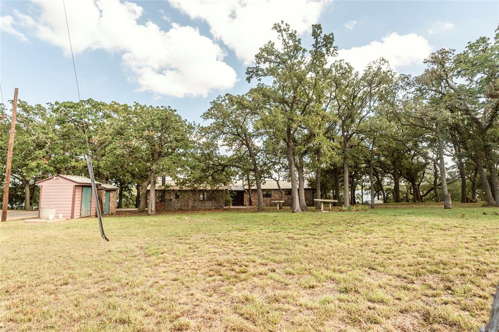 722 Storey Road Nocona, TX 76255 - Photo 39 of 40 a view of a yard with a trees
