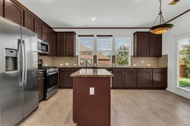a open kitchen with a sink and dishwasher with a large window