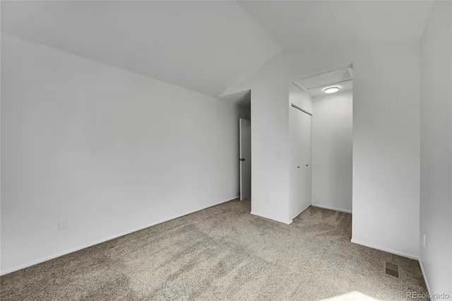 a bathroom with a granite countertop toilet a sink and mirror
