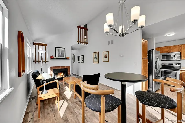 a view of a dining room with furniture and a chandelier
