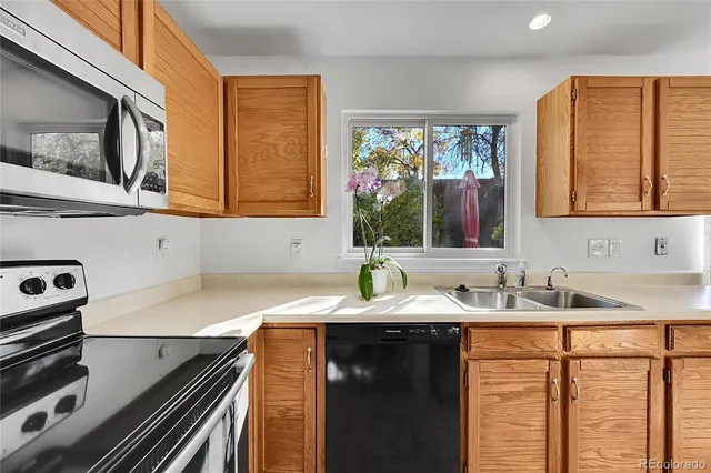 a bathroom with a granite countertop sink and a window
