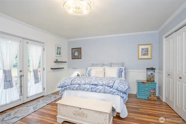 a bedroom with a bed and a chandelier