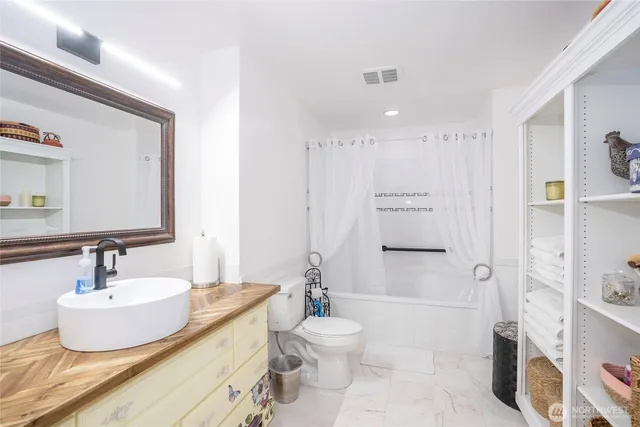 a bathroom with a toilet sink and shower
