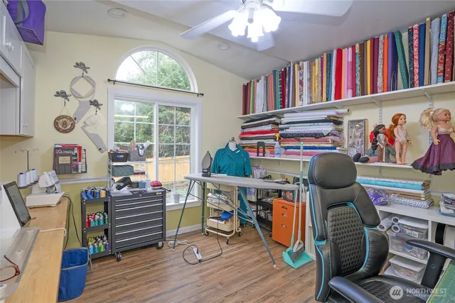 a living room with furniture a rug and a bookshelf