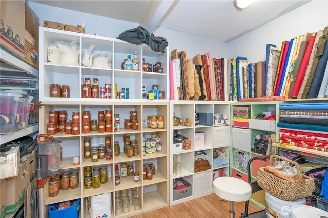 a room with lots of furniture and a book shelf