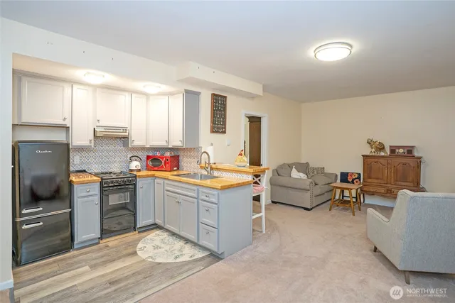 a kitchen with sink refrigerator and stove