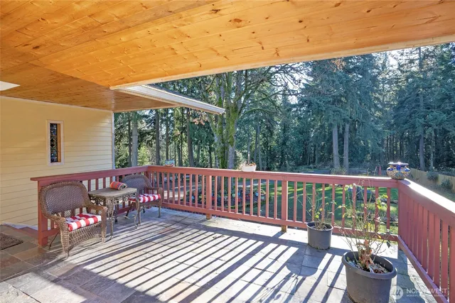 a view of a wooden deck with furniture