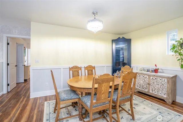 a view of a dining room with furniture and wooden floor