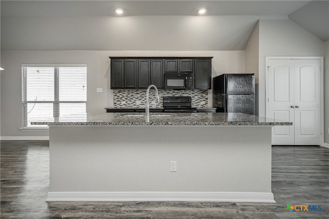 8109 Northgate Loop Temple, TX 76502 - Photo 13 of 35 a kitchen with stainless steel appliances a sink and a refrigerator