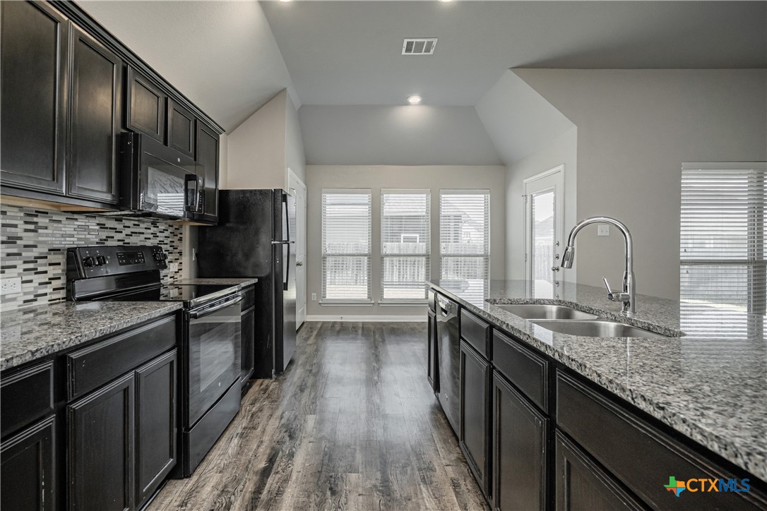 8109 Northgate Loop Temple, TX 76502 - Photo 19 of 35 a kitchen with stainless steel appliances granite countertop a sink stove and refrigerator