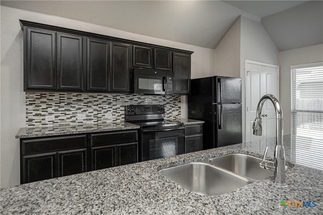 8109 Northgate Loop Temple, TX 76502 - Photo 20 of 35 a kitchen with a sink stove and refrigerator