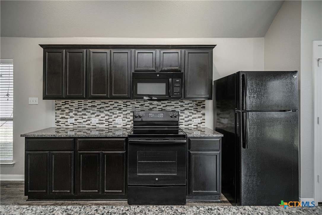 8109 Northgate Loop Temple, TX 76502 - Photo 21 of 35 a kitchen with a refrigerator and cabinets
