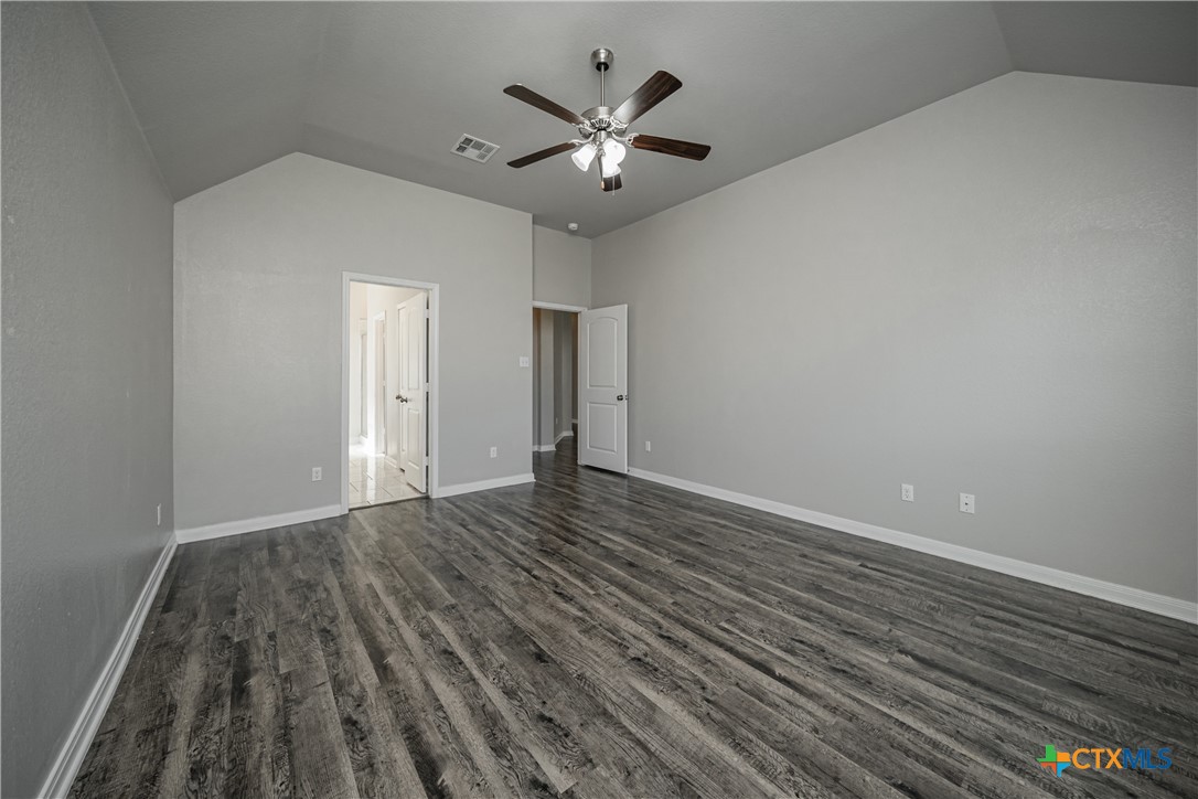 8109 Northgate Loop Temple, TX 76502 - Photo 24 of 35 a view of an empty room with chandelier fan and wooden floor