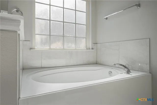 a white bath tub sitting next to a window