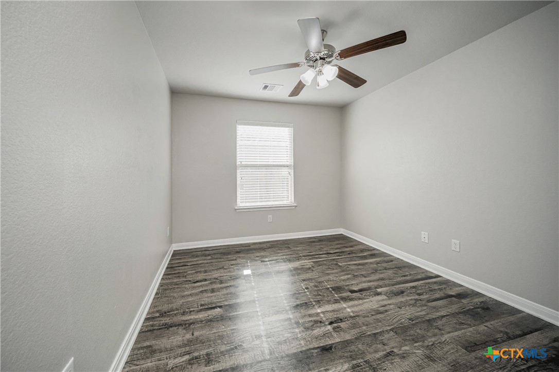 8109 Northgate Loop Temple, TX 76502 - Photo 34 of 35 an empty room with wooden floor fan and windows