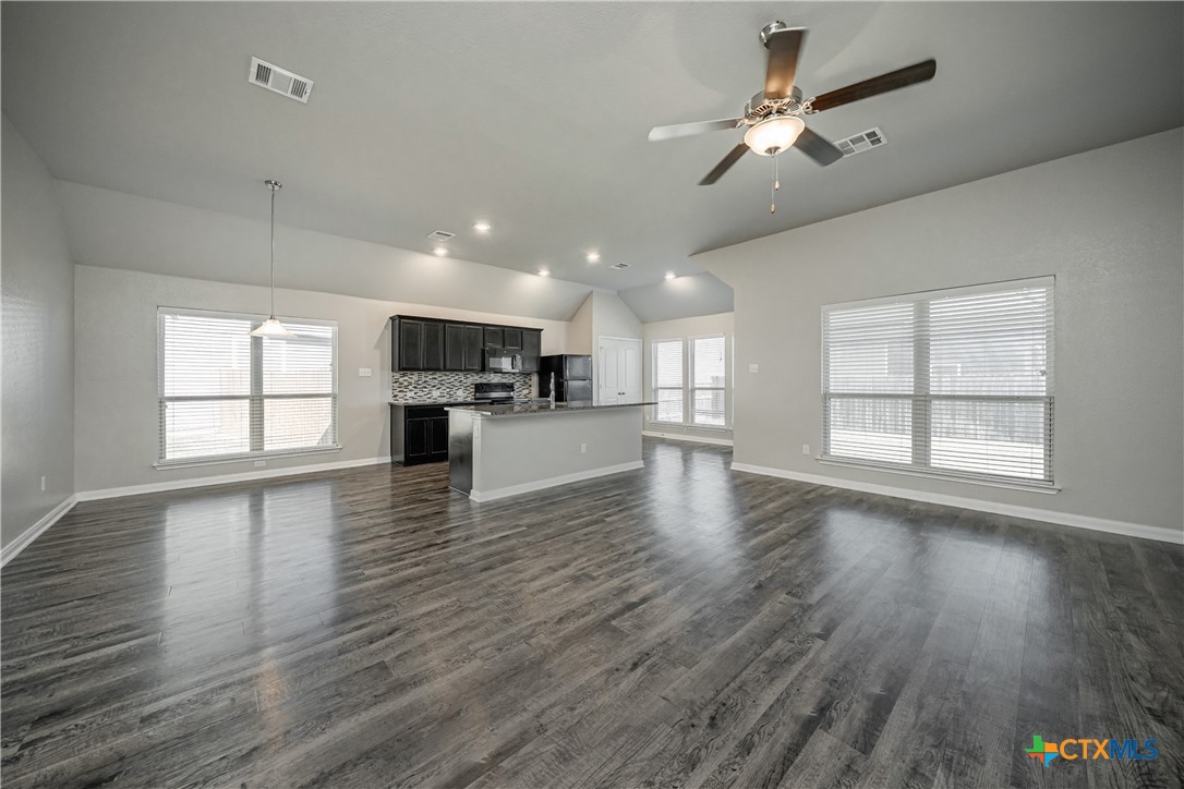 8109 Northgate Loop Temple, TX 76502 - Photo 5 of 35 a view of a kitchen with furniture a ceiling fan and wooden floor