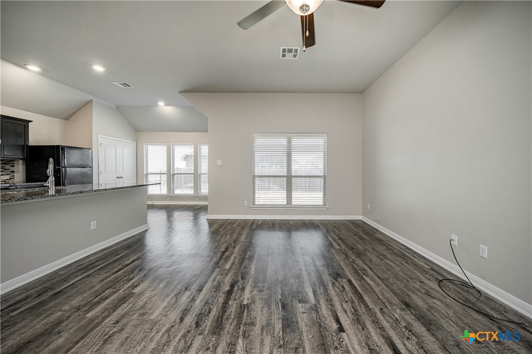 8109 Northgate Loop Temple, TX 76502 - Photo 8 of 35 a view of an empty room with wooden floor and a window