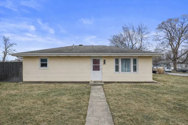 a view of a house with a backyard