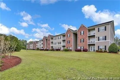 a large building with a big yard and large trees