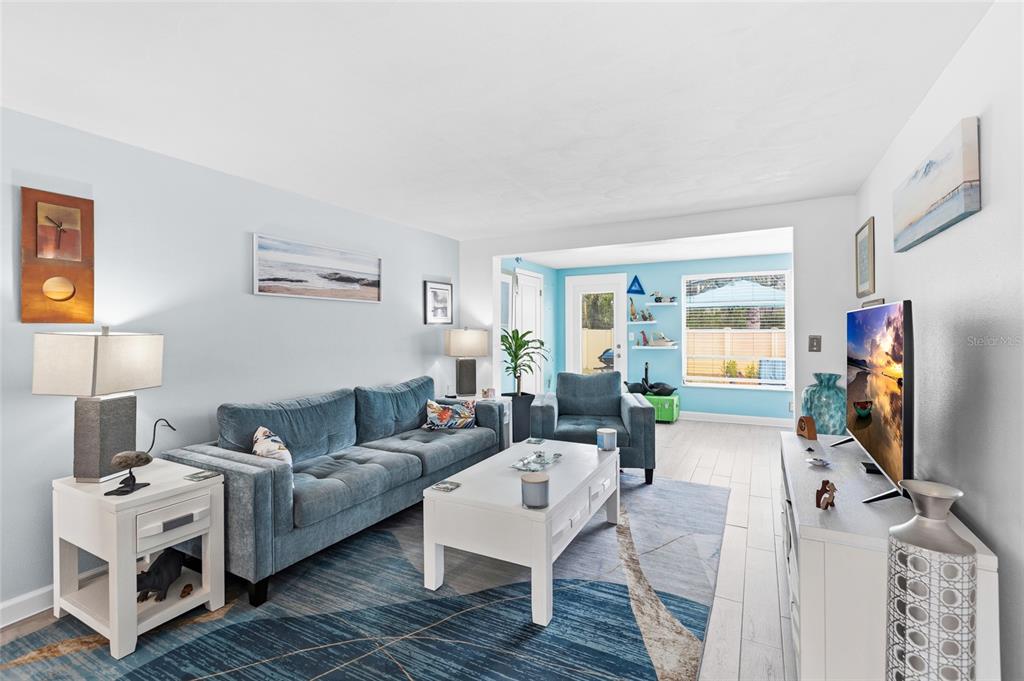 4467 Rustic Drive New Port Richey, FL 34652 - Photo 12 of 44 a living room with furniture and a flat screen tv