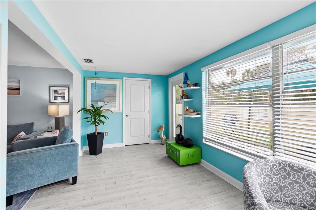 4467 Rustic Drive New Port Richey, FL 34652 - Photo 15 of 44 a view of an entryway with wooden floor and a livingroom