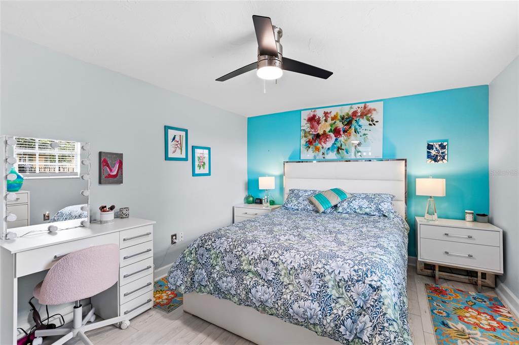 4467 Rustic Drive New Port Richey, FL 34652 - Photo 18 of 44 a bedroom with a bed and a desk