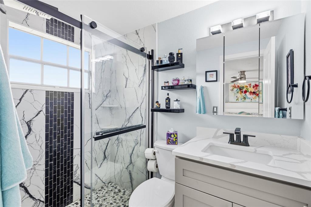 4467 Rustic Drive New Port Richey, FL 34652 - Photo 19 of 44 a bathroom with a sink and a shower curtain