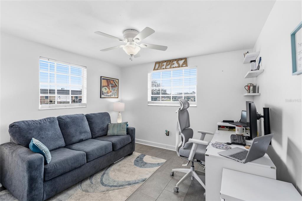 4467 Rustic Drive New Port Richey, FL 34652 - Photo 20 of 44 a living room with furniture a flat screen tv and a window