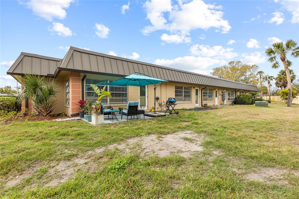 4467 Rustic Drive New Port Richey, FL 34652 - Photo 24 of 44 a front view of a house with a yard porch and outdoor seating