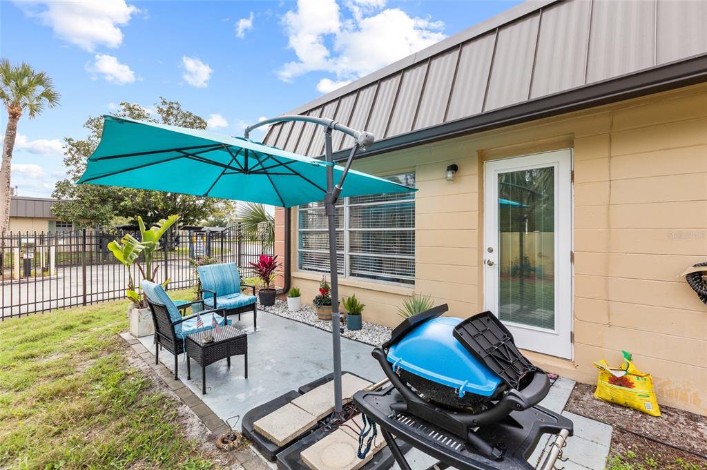 4467 Rustic Drive New Port Richey, FL 34652 - Photo 27 of 44 a outdoor living space with furniture and umbrella