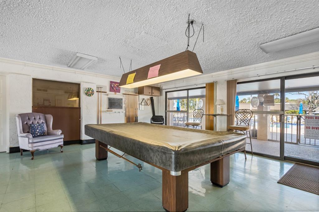 4467 Rustic Drive New Port Richey, FL 34652 - Photo 30 of 44 a room with pool table and windows