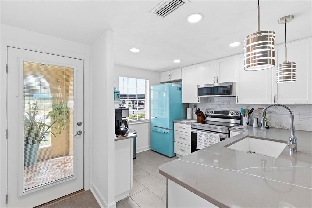 4467 Rustic Drive New Port Richey, FL 34652 - Photo 4 of 44 a kitchen with stainless steel appliances a stove sink and refrigerator