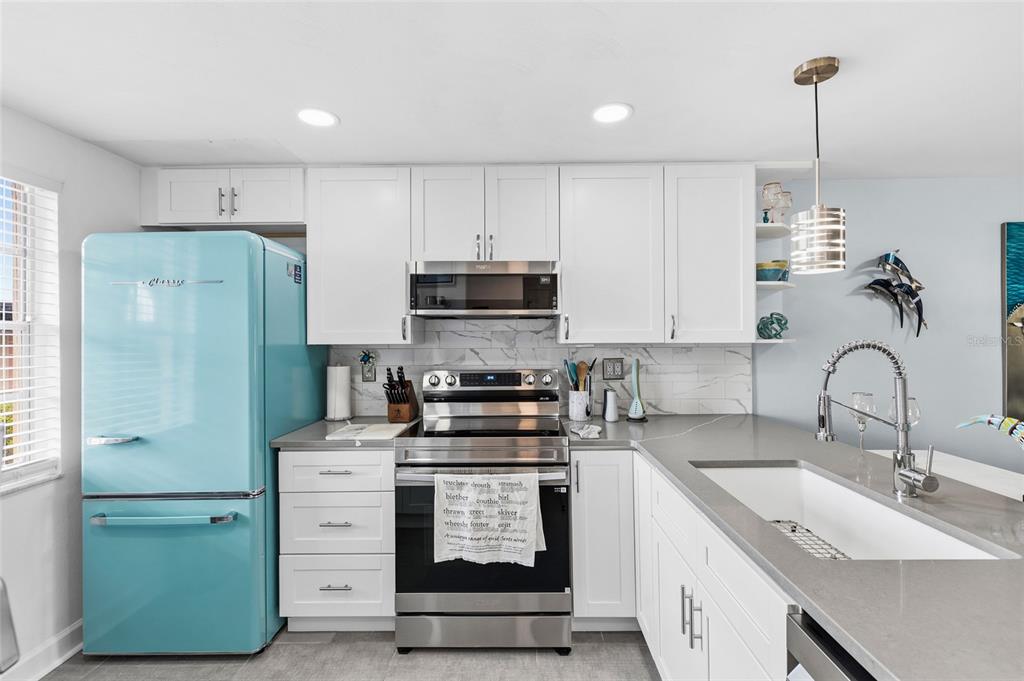4467 Rustic Drive New Port Richey, FL 34652 - Photo 5 of 44 a kitchen with cabinets appliances and a sink