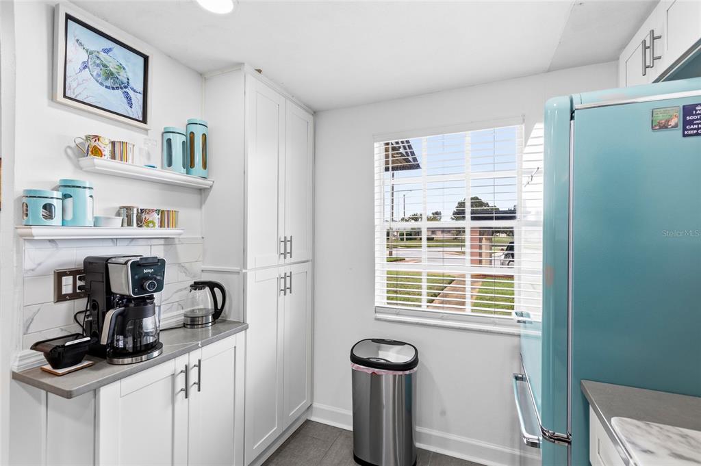 4467 Rustic Drive New Port Richey, FL 34652 - Photo 6 of 44 a kitchen with stainless steel appliances a sink a refrigerator and window