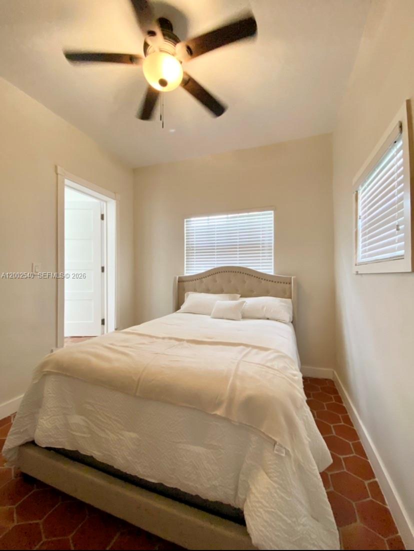 4619 Southwest 10th Street Miami, FL 33134 - Photo 11 of 30 a bedroom with a bed and a ceiling fan