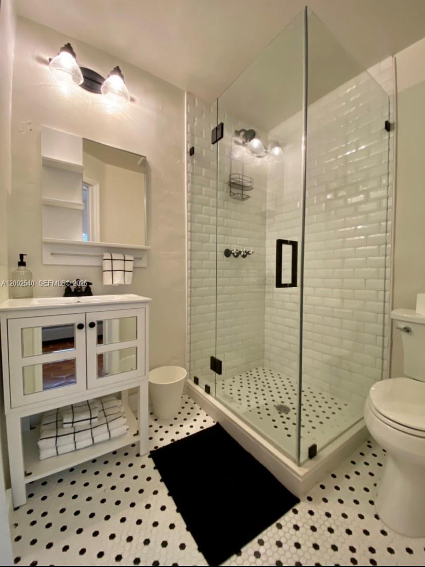 4619 Southwest 10th Street Miami, FL 33134 - Photo 13 of 30 a bathroom with a sink a toilet a shower and a mirror