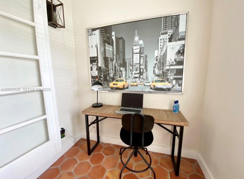 4619 Southwest 10th Street Miami, FL 33134 - Photo 14 of 30 a view of a workspace with furniture and a window