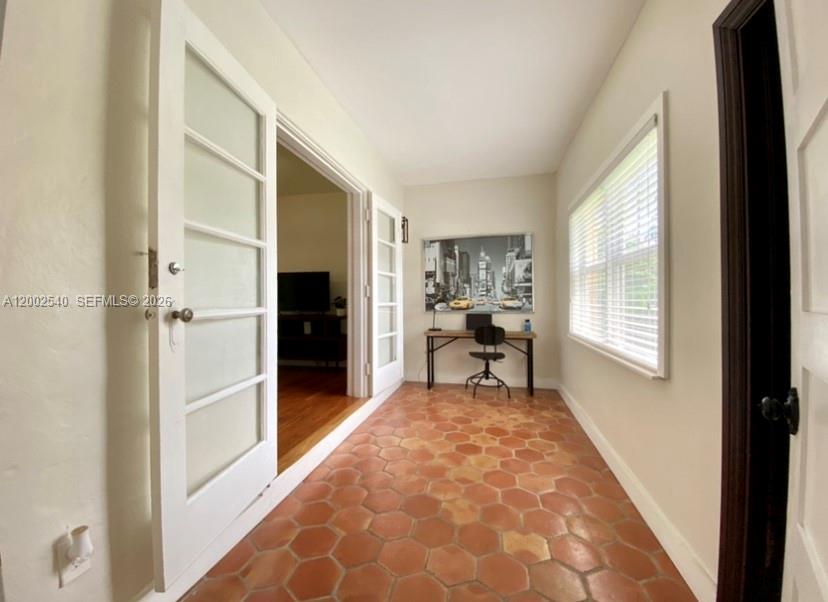 4619 Southwest 10th Street Miami, FL 33134 - Photo 16 of 30 a view of a hallway to a livingroom with furniture and windows