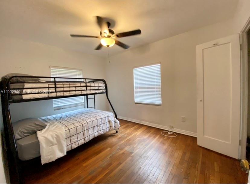 4619 Southwest 10th Street Miami, FL 33134 - Photo 24 of 30 a bedroom with a bed and wooden floor