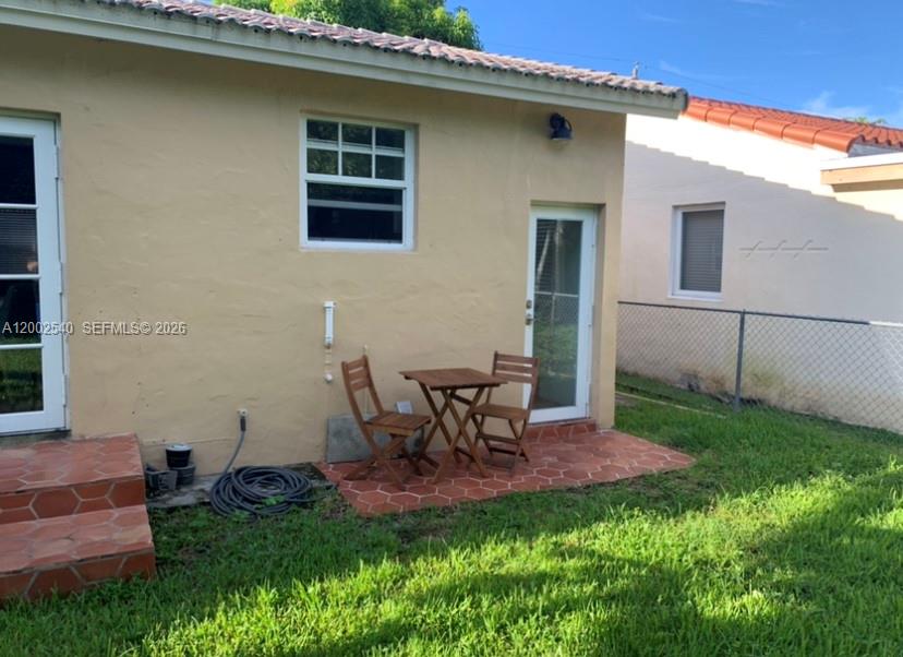 4619 Southwest 10th Street Miami, FL 33134 - Photo 28 of 30 a view of a backyard with table and chairs and potted plants