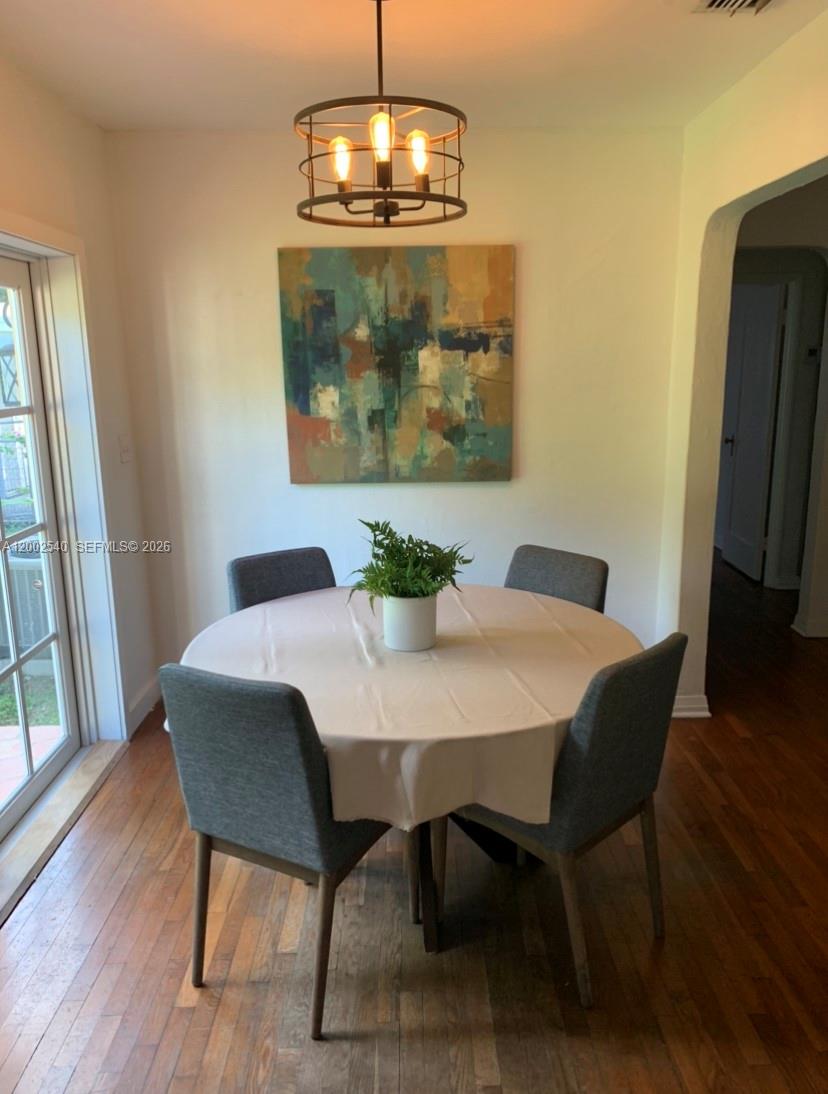 4619 Southwest 10th Street Miami, FL 33134 - Photo 4 of 30 a view of a dining room with furniture wooden floor and chandelier