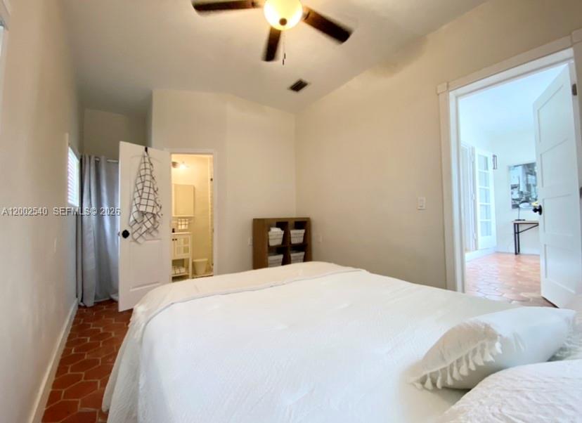 4619 Southwest 10th Street Miami, FL 33134 - Photo 10 of 30 a bedroom with a bed and a chandelier