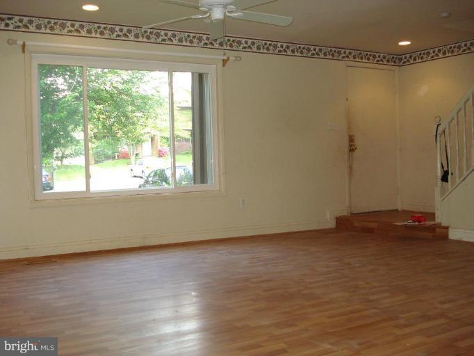 9072 Centerway Road Gaithersburg, MD 20879 - Photo 2 of 15 a view of a room with wooden floor and windows