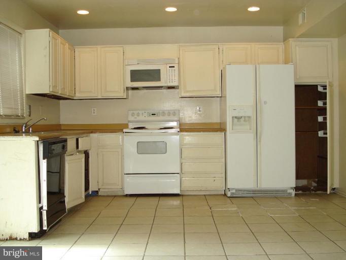 9072 Centerway Road Gaithersburg, MD 20879 - Photo 5 of 15 a utility room with cabinets washer and dryer