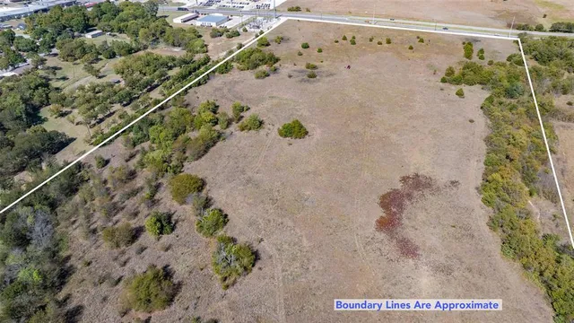 a view of a field with an ocean view